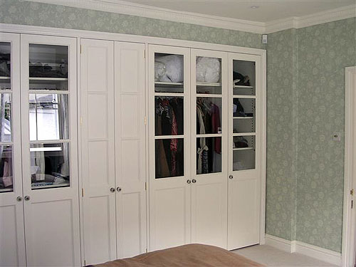 White painted bedroom units with half-glazed doors