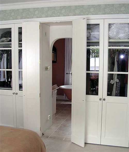 White painted bedroom units with doors open showing walk-through