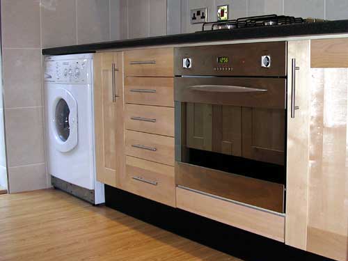 Contemporary kitchen with black laminate worktops #1
