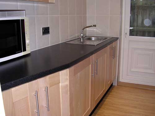 Contemporary kitchen with black laminate worktops #2
