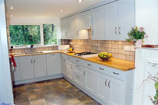 Grey painted shaker kitchen with teak worktops